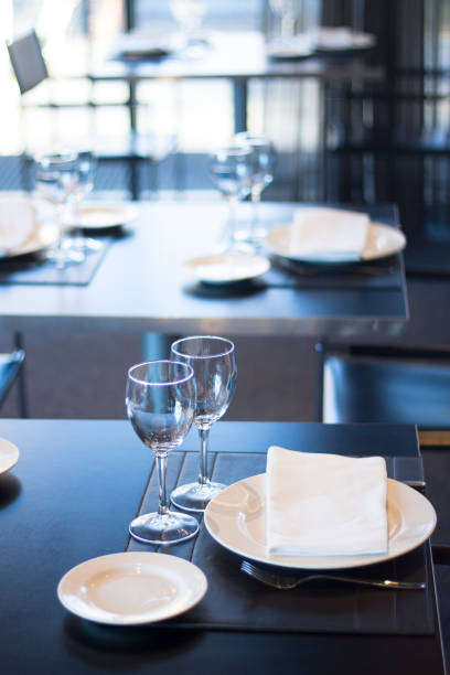 istock Restaurant cafe bar in luxury hotel with place settings for breakfast, lunch and dinner with wine water glasses 951972502