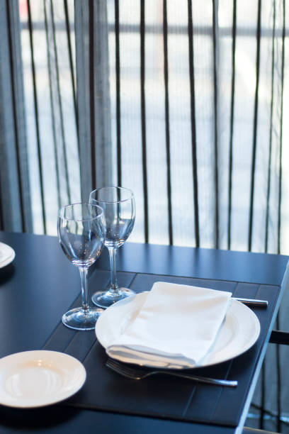 istock Restaurant cafe bar in luxury hotel with place settings for breakfast, lunch and dinner with wine water glasses 951972508