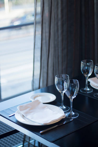 istock Restaurant cafe bar in luxury hotel with place settings for breakfast, lunch and dinner with wine water glasses 951972548