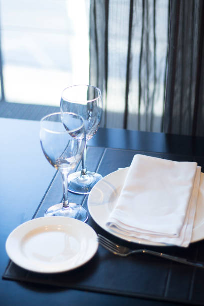 istock Restaurant cafe bar in luxury hotel with place settings for breakfast, lunch and dinner with wine water glasses 951972580