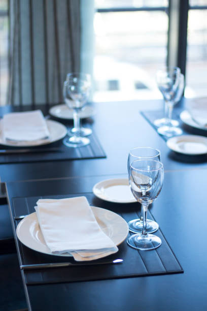 istock Restaurant cafe bar in luxury hotel with place settings for breakfast, lunch and dinner with wine water glasses 951972608