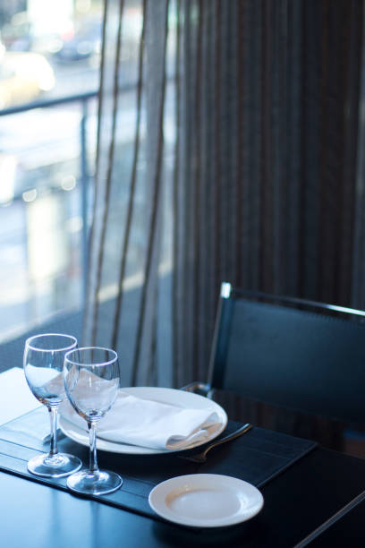 istock Restaurant cafe bar in luxury hotel with place settings for breakfast, lunch and dinner with wine water glasses 951972614