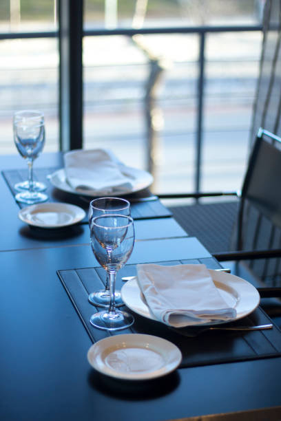 istock Restaurant cafe bar in luxury hotel with place settings for breakfast, lunch and dinner with wine water glasses 951972618