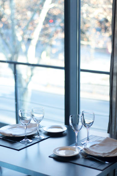 istock Restaurant cafe bar in luxury hotel with place settings for breakfast, lunch and dinner with wine water glasses 951972640
