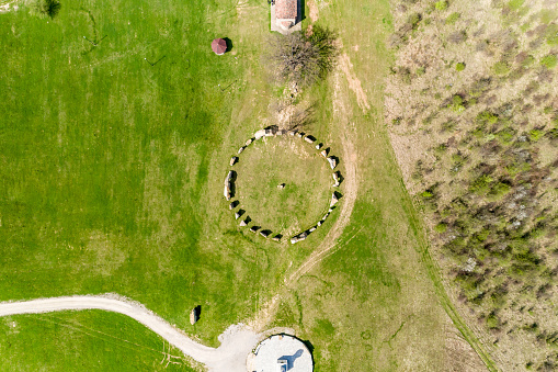 High up eagle-eye aerial view of Stonehenge like structure in Rayuvtsi village, Bulgaria. The scene is situated in Rayuvtsi village near Elena, Bulgaria (Eastern Europe) during day. The footage is taken with DJI Phantom 4 Pro drone.
