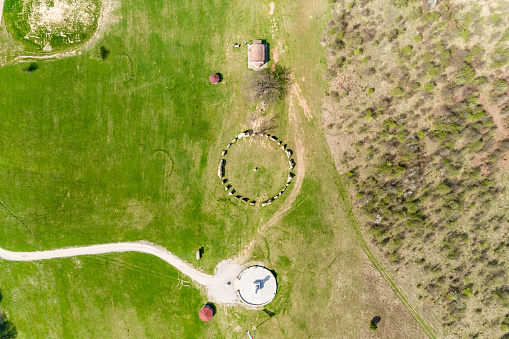 High above eagle-eye aerial view of Stonehenge like structure in Rayuvtsi village, Bulgaria. The scene is situated in Rayuvtsi village near Elena, Bulgaria (Eastern Europe) during day. The footage is taken with DJI Phantom 4 Pro drone.