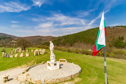 Bulgarian national flag waving proudly in front of gorgeous landscape. The scene is situated in Rayuvtsi village near Elena, Bulgaria (Eastern Europe) during day. The footage is taken with DJI Phantom 4 Pro drone.
