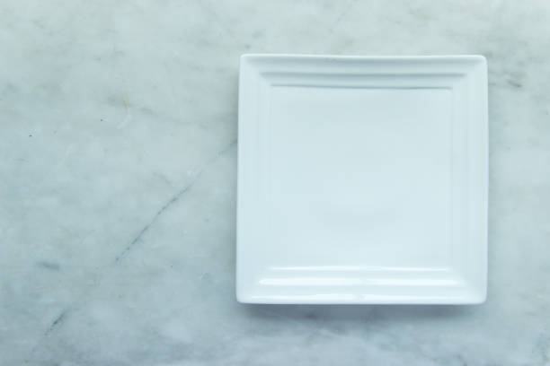 istock Top view, Closed up empty blank dishware on wooden tray and place on grey granite table. 951993414