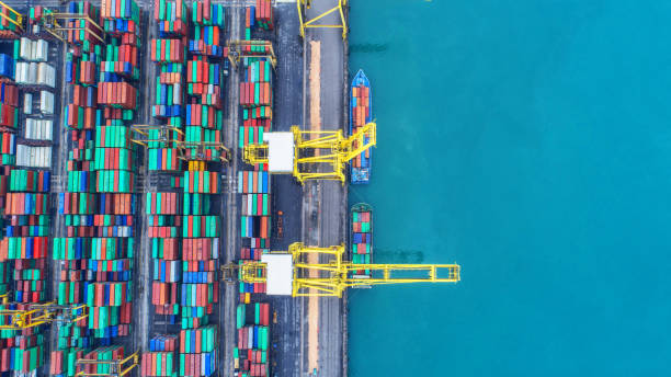 istock Container ship in export and import business and logistics. Shipping cargo to harbor by crane. Water transport International. Aerial view and top view. 951995398