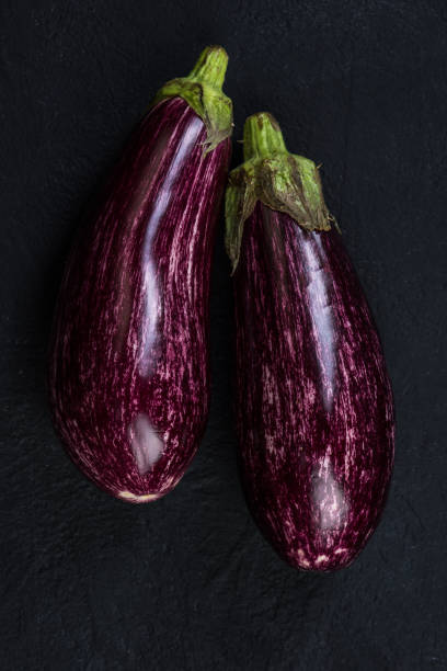 istock Pink or purple aubergine on dark slate 951995954