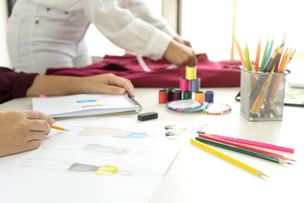 istock professional Fashion designer working and drawing sketches 951996354
