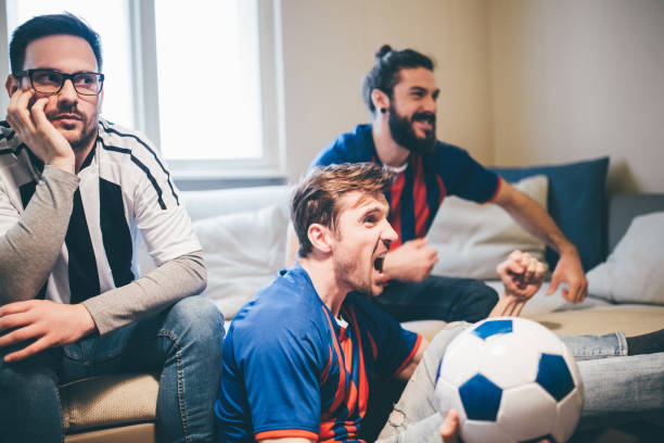 istock Men shouting while watching soccer game with friends 951996490