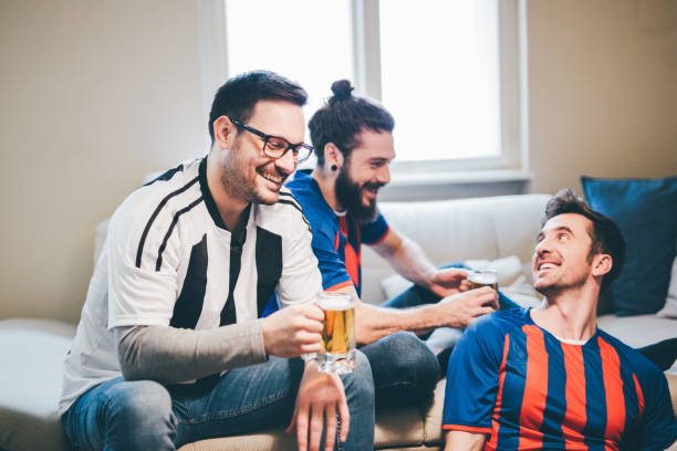 istock Happy people watching soccer and drinking beer 951996776