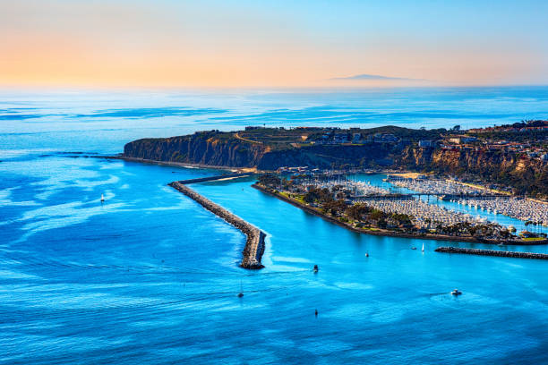 The peninsula of Dana Point, California and it's harbor located in the southern portion of Orange County shot from an altitude of about 1500 feet nearing sunset.