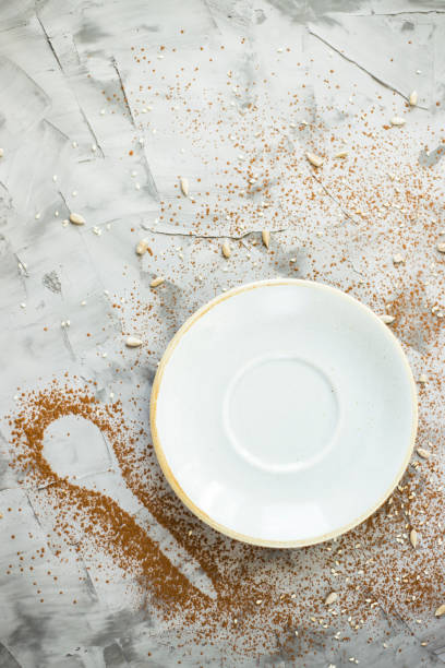 istock Empty blue small plate next to a spoonful of cocoa on a gray background. Copyspace 951999888