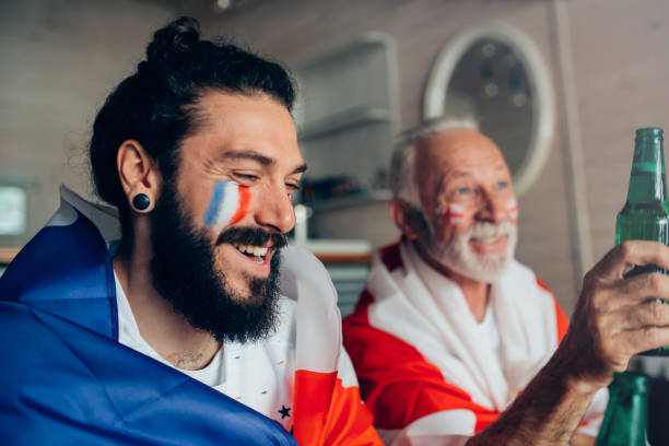 istock Family supporting different national teams on a world soccer championship watching game together 952000332