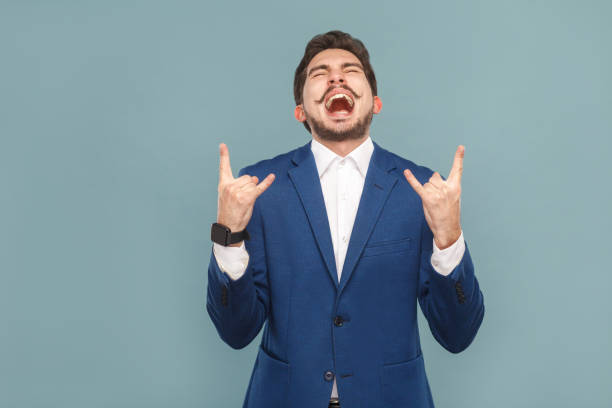 istock Businessman shout and showing rock and roll sign 952000532