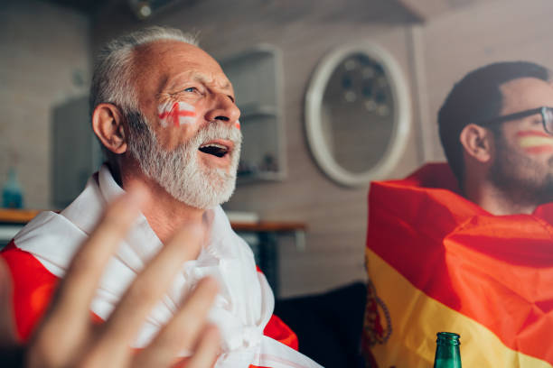 istock Nervous men supporting different national teams and watching soccer game 952000692