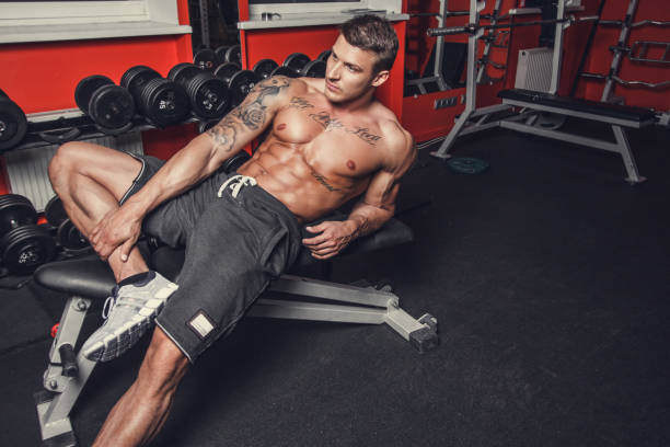 a  man resting after workouts. - muscular build men tattoo human arm imagens e fotografias de stock