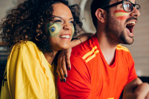 istock Couple watching soccer game on TV, making faces and shouting 952002072