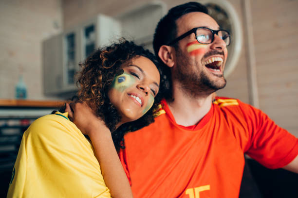 istock Couple watching soccer game on TV and hugging 952002076