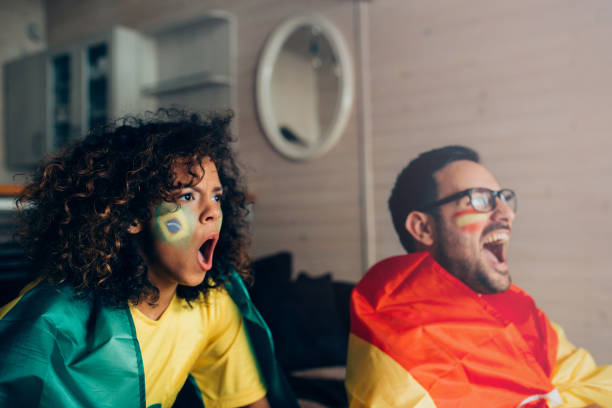 istock Surprised couple watching soccer game on TV 952002360