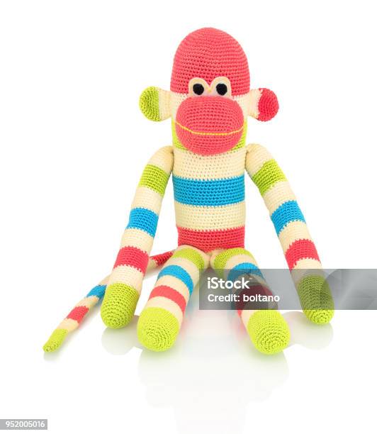 Cute Handmade Crochet Monkey Doll Isolated On White Background With Shadow Reflection Playful Crochet Green Pink Blue White Monkey Sitting On White Underlay Knitted Ape Stock Photo - Download Image Now