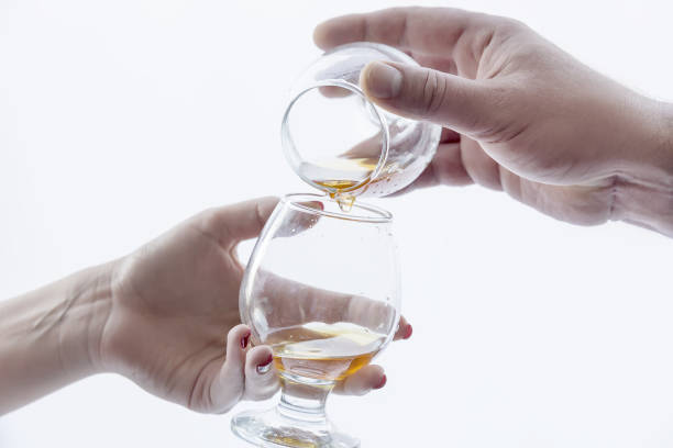 istock two hands, two glasses of alcohol . 952005880