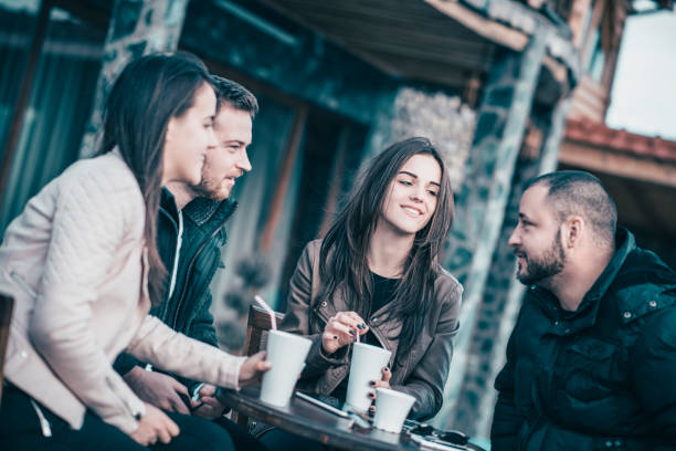istock Group of Smiling Friends Having Conversation in a Coffee Restaurant 952007794