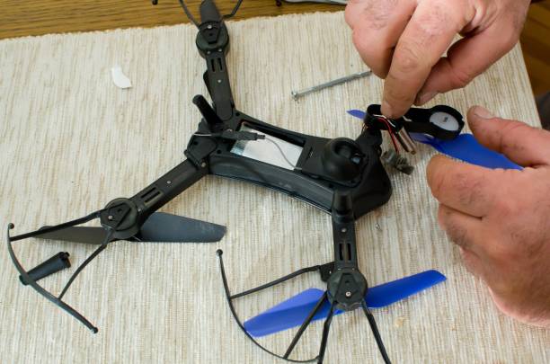 istock man repairing small black drone 952008172