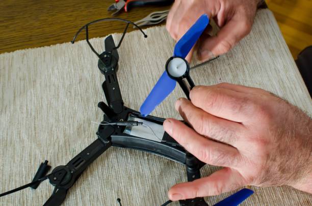 istock man repairing small black drone 952008182