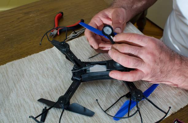 istock man repairing small black drone 952008228