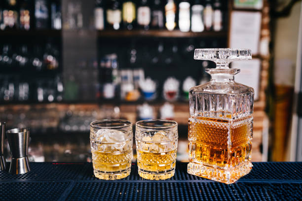 istock Two crystal glasses on bar counter with whiskey and ice 952008690