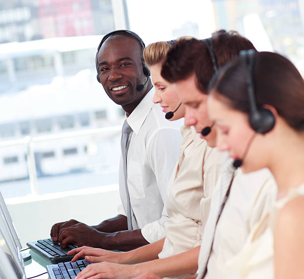istock Man smiling at camera in a call center 95201048