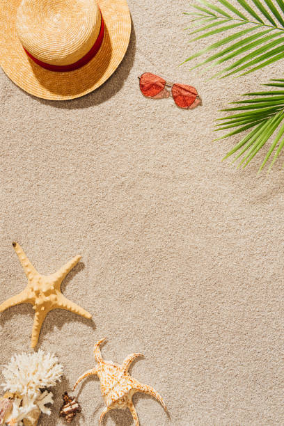istock top view of straw hat with sunglasses on sandy beach 952010560