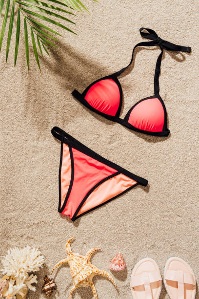 istock top view of stylish bikini lying on sandy beach 952011812