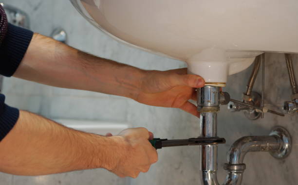 istock Plumbing repair service. Professional installer with spanner checking pipe. 952012032