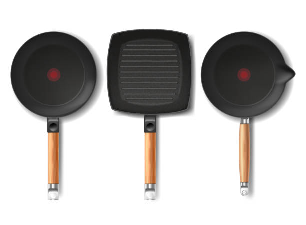 Vector three black frying pans of various shapes Vector set with realistic black frying pans of various shapes, with red thermo-spot indicator and non-stick coating isolated on background. Modern cookware, kitchen equipment for frying, cooking food stuck in room stock illustrations
