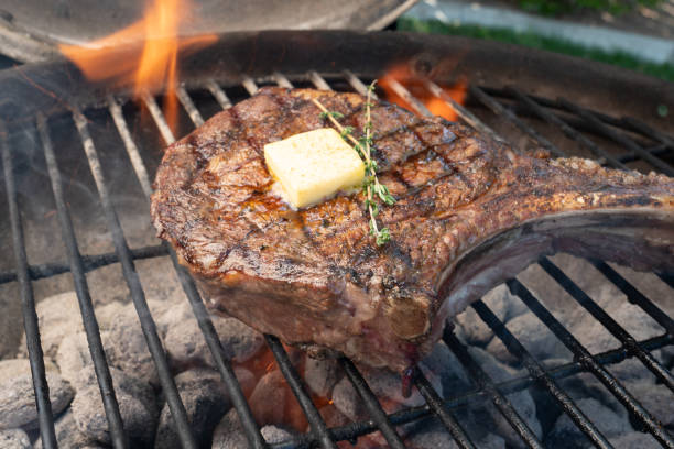 istock Large Raw Cowboy Cut Rib Eye Steak on the Grill 952017348