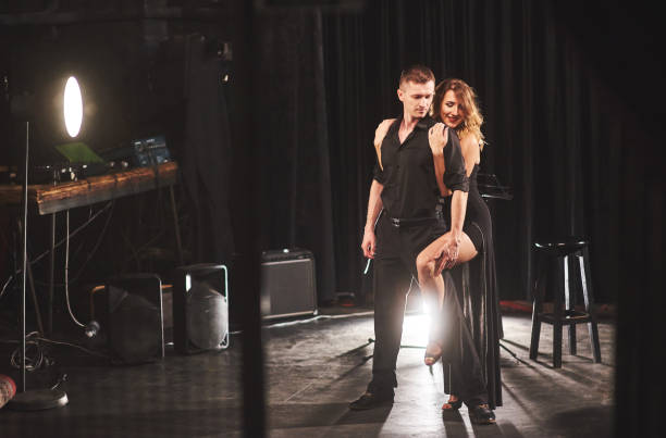 istock Skillful dancers performing in the dark room under the light 952017764