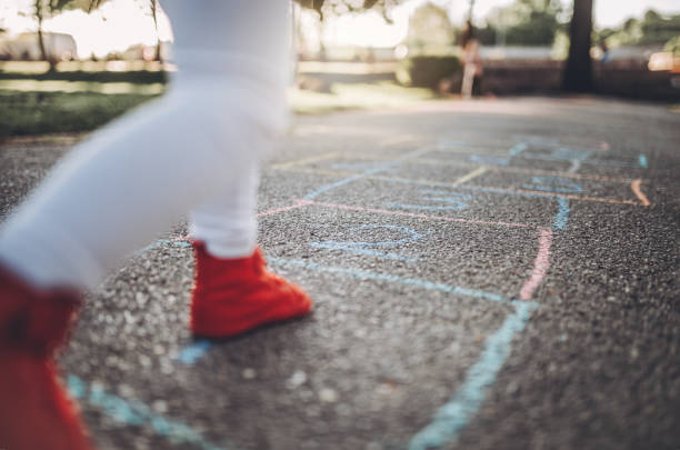 istock Child playing hopscotch on a playground 952018328