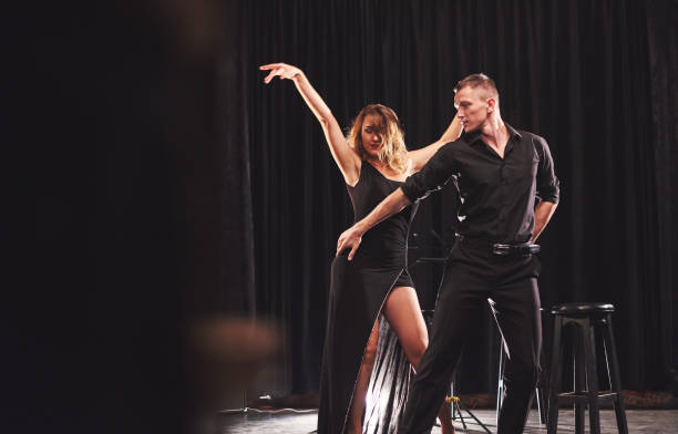 istock Skillful dancers performing in the dark room under the light 952018806