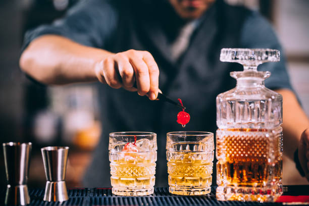 istock bartender preparing and lining crystal whisekey glasses for alcoholic drinks on bar 952021658