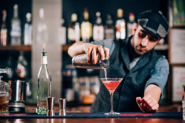 istock Barman pouring fresh cosmopolitan drink 952022404