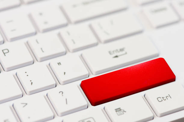 close up red button on white laptop keyboard stock photo
