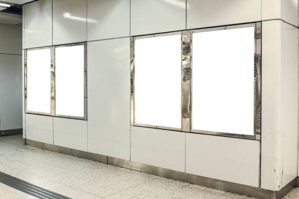 istock Four portrait orientation blank mock up advertisement light boxes at a metro station 952025580
