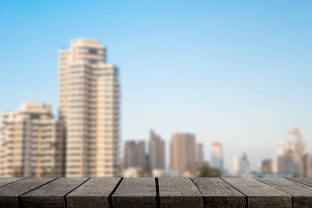 istock Empty brown wooden shelf with City background 952035034