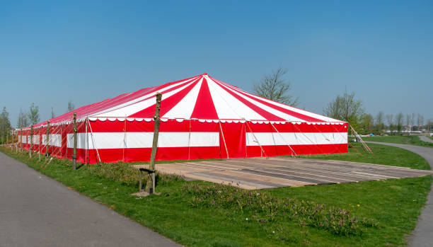 istock Red white party tent in public park 952036124