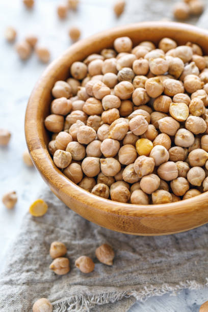 istock Dry chickpeas in a wooden bowl closeup. 952037552