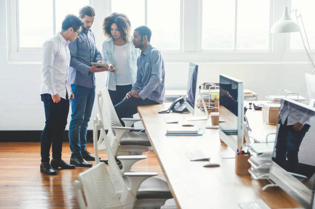istock Group of young business people with technology. 952039658